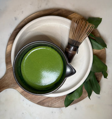 a bowl of mind&leaf matcha with a bamboo whisk, prepared for a calm, focused morning